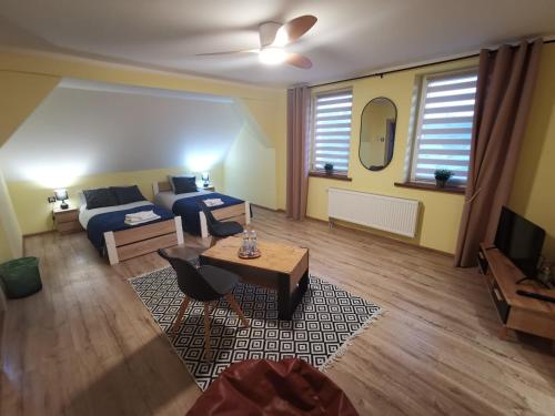 a living room with a bed and a couch at Gościniec Trzebiel in Trzebiel