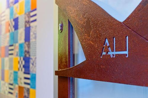 a wooden object with the word al on it at Airone Hotel in Naples