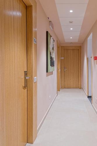 a hallway of a hospital with wooden doors at Airone Hotel in Naples