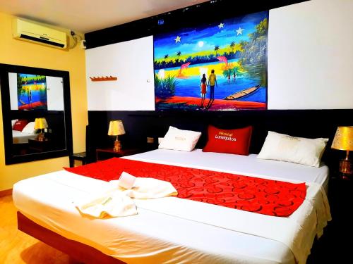 a bedroom with two beds with a large painting on the wall at HOTEL LUNA Iquitos in Iquitos