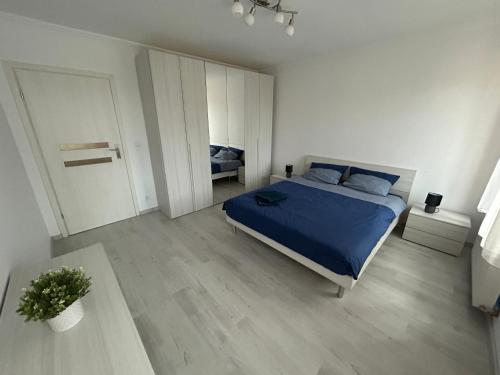 a bedroom with a bed with a blue comforter at Chez Aurel & Manu in Sainte-Marie-aux-Mines