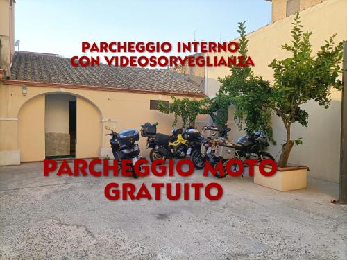 a couple of motorcycles parked outside of a building at Domos La Corte Ghibellina in Iglesias