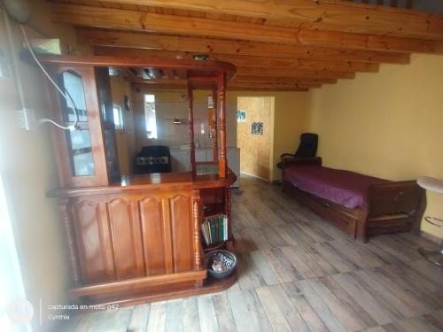 a room with a large wooden cabinet and a bed at Alborada Hostel in Resistencia