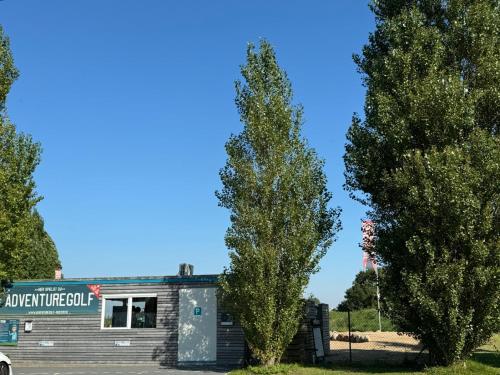 a building with trees in front of it at Ferienhaus Enjoy in Büsum