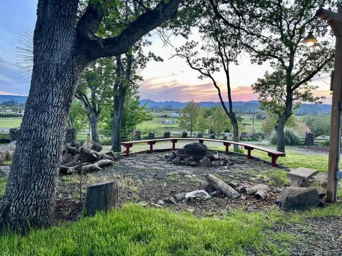 a fire pit in a park with a tree at Cascade Sunset House - Crater Lake Adventures! in Eagle Point