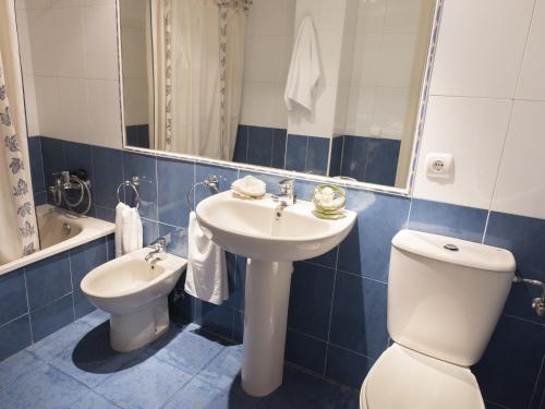 a bathroom with a sink and a toilet and a mirror at Turquesa Beach Unitursa in Calpe