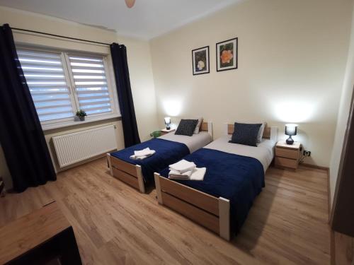 a bedroom with two beds and a window at Gościniec Trzebiel in Trzebiel