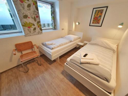 a small bedroom with a bed and a chair at Aparthotel B & L in Bremen