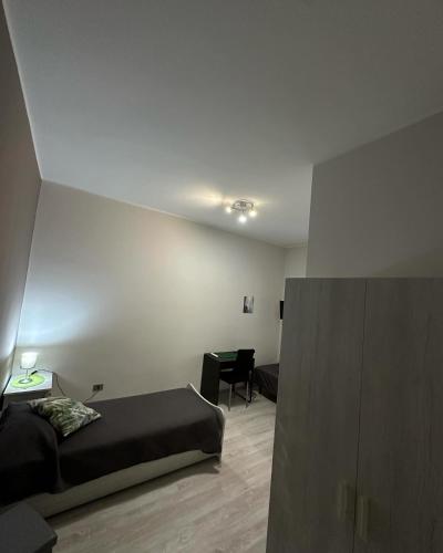 a bedroom with a bed and a chair in a room at Family in Potenza