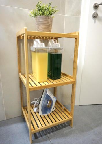 a wooden shelf with a scale and a plant at MT Living - private Terasse - Whirlpool in Aschaffenburg