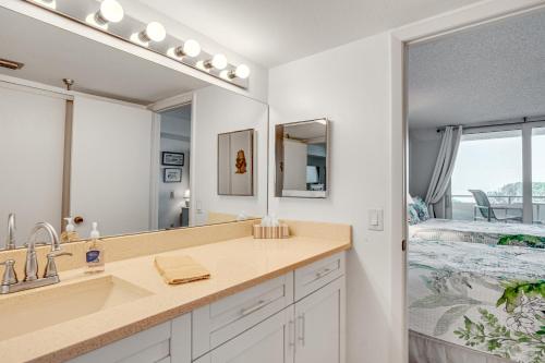 a bathroom with a sink and a mirror and a bed at Balcony and Resort Amenities Gulf Coast Escape! in Hudson