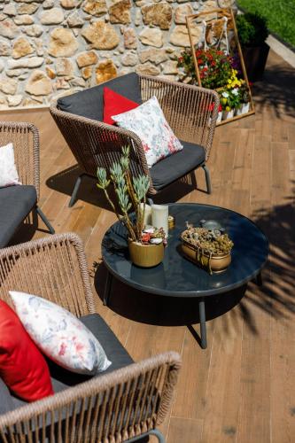 a patio with a table and chairs with pillows at Deluxe Villa Home, Peace & Spa in Vila do Conde