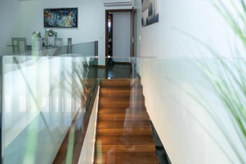 a hallway with a glass table and a stairway at Deluxe Villa Home, Peace & Spa in Vila do Conde