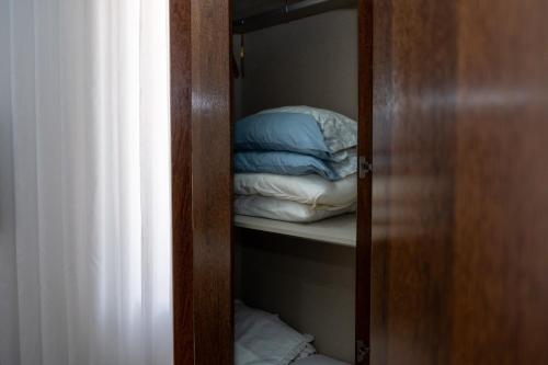 a closet with a stack of pillows in it at Deluxe Villa Home, Peace & Spa in Vila do Conde