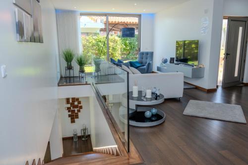 a living room with a glass table and a couch at Deluxe Villa Home, Peace & Spa in Vila do Conde