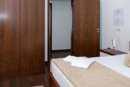 a bedroom with two white towels on a bed at Deluxe Villa Home, Peace & Spa in Vila do Conde