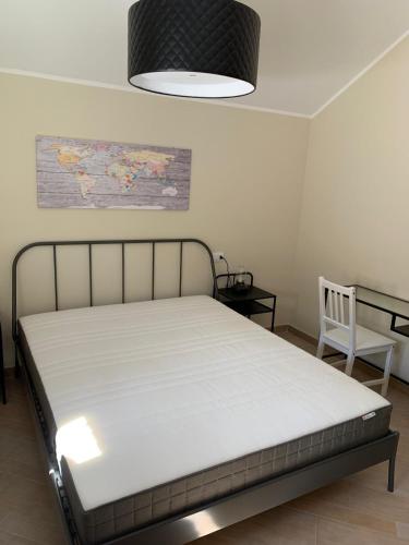 a bedroom with a bed and a chair in it at Home Berardi in Tagliacozzo