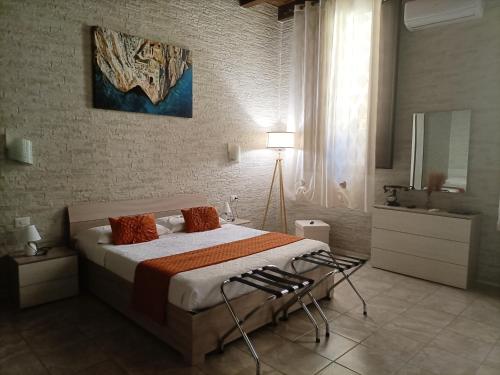 a bedroom with a large bed and a bathroom at Domos La Corte Ghibellina in Iglesias