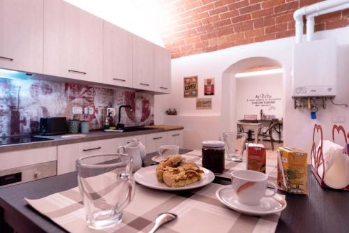 a kitchen with a table with a plate of food on it at Il Gatto e La Volpe in Terricciola
