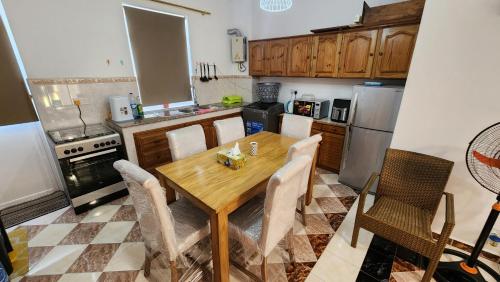 a kitchen with a wooden table and chairs at 2 bedroom apartment in Bain Boeuf in Cap Malheureux