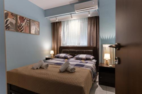 a bedroom with a bed with towels on it at La Bella Casa Thessaloniki in Thessaloniki