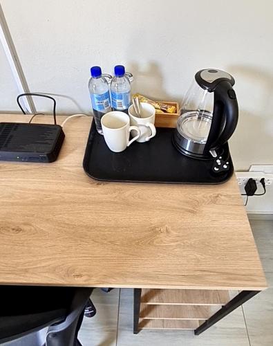 a table with a coffee maker and cups on it at Lukhanyo Guest House in Northam