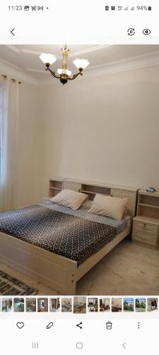 a bedroom with a bed with a chandelier at Demeure coup de cœur in LʼAgha