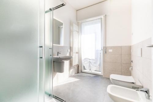 a white bathroom with a sink and a shower at Residence Signoria degli Scaligeri in Verona