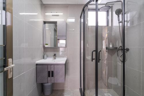 a bathroom with a sink and a shower at Airy Apartment with Gym, Stunning View in Westlands in Nairobi