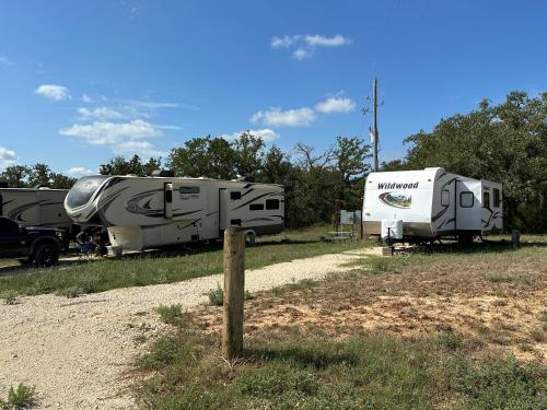 two rvs parked next to each other in a field at County Chic Pets Ok Tx Motor Speedway Nearby By Vacation Your Way in Fort Worth