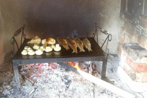 a bunch of food cooking in an oven at Cottage Eminem with garden and view of Sarajevo in Hadžići