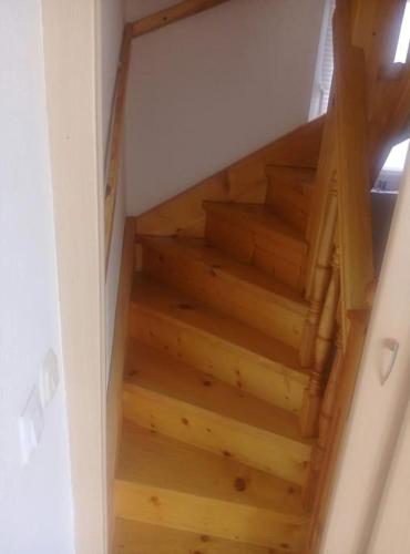 an overhead view of a wooden staircase in a house at Cottage Eminem with garden and view of Sarajevo in Hadžići