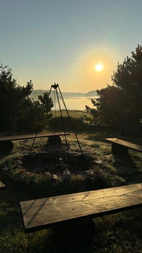 a fire pit with the sunset in the background at Apartamenty Lobeliowy Port in Borzyszkowy