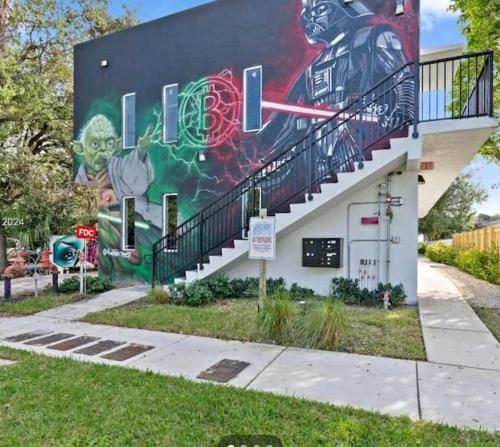 a mural on the side of a building with a staircase at Atrium Star Wars-themed Design District in Miami