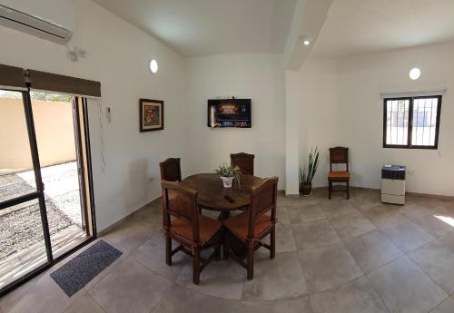 a dining room with a wooden table and chairs at Como en casa in San Fernando del Valle de Catamarca