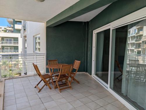 a patio with a table and chairs on a balcony at FortCambridge 2BR, pool, Terrace in Sliema