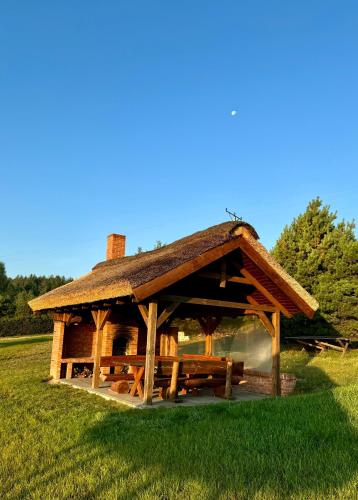 a large wooden pavilion in a field of grass at Apartamenty Lobeliowy Port in Borzyszkowy