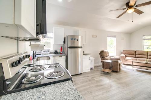 a kitchen with a stove and a refrigerator at Grove Cabin - Walk to Grand Lake o the Cherokees! in Grove