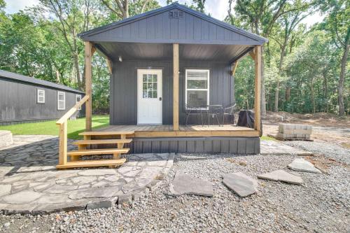 a tiny house with a porch and a deck at Grove Cabin - Walk to Grand Lake o the Cherokees! in Grove