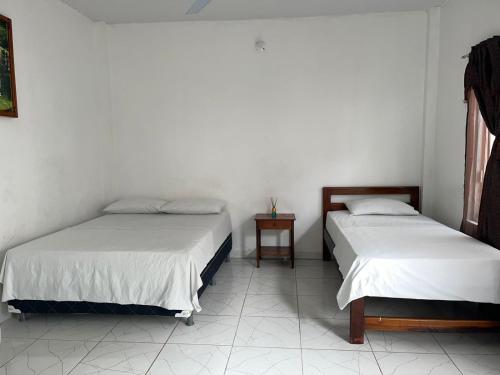 Кровать или кровати в номере Hotel heliconias