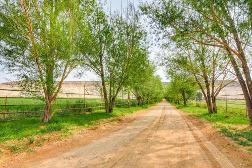 a dirt road with trees and a fence at Ranch House in Boulder! Gateway to Nearby Parks! in Boulder Town