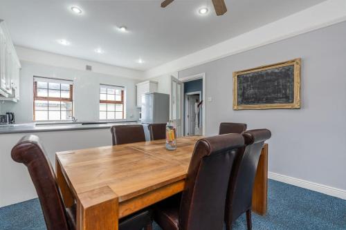a dining room with a wooden table and chairs at City Centre Townhouse - just off Medieval Mile in Kilkenny