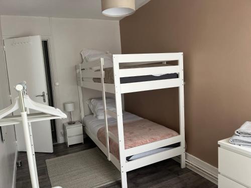 a white bunk bed in a small room at La Maison d Elodie in Vierzon