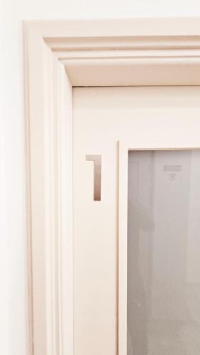 a white door with a window and a handle at Rooms4you 1 in historic center of Braga in Braga