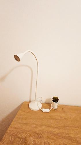 a white lamp sitting on top of a wooden table at Rooms4you 1 in historic center of Braga in Braga
