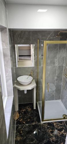a bathroom with a sink and a shower at MSM Arena Hotel in London