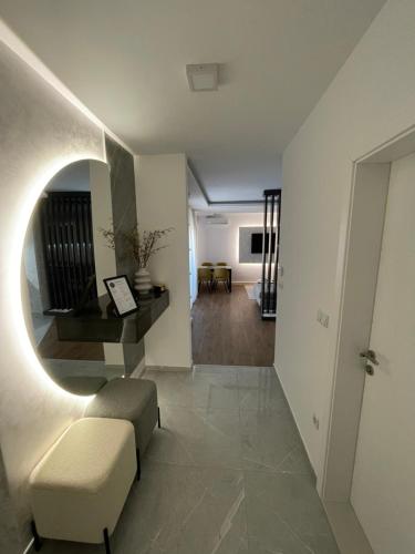 a living room with a couch and a chair in a room at Delux apartman President Centar II in Brčko