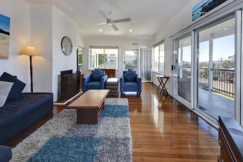 a living room with a couch and chairs and a table at Summer Salt - 13-15 Sturt Street South West Rocks in South West Rocks