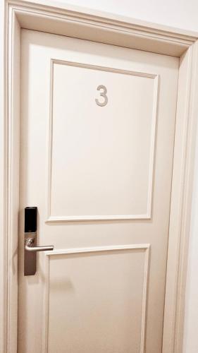 a white door with the number three on it at Rooms4you 1 in historic center of Braga in Braga