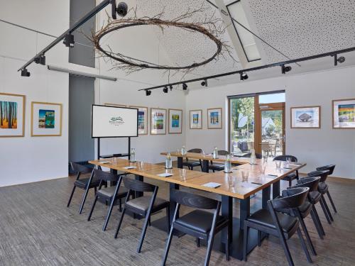 a conference room with a long table and chairs at Hotel Panská Zahrada in Dobřichovice
